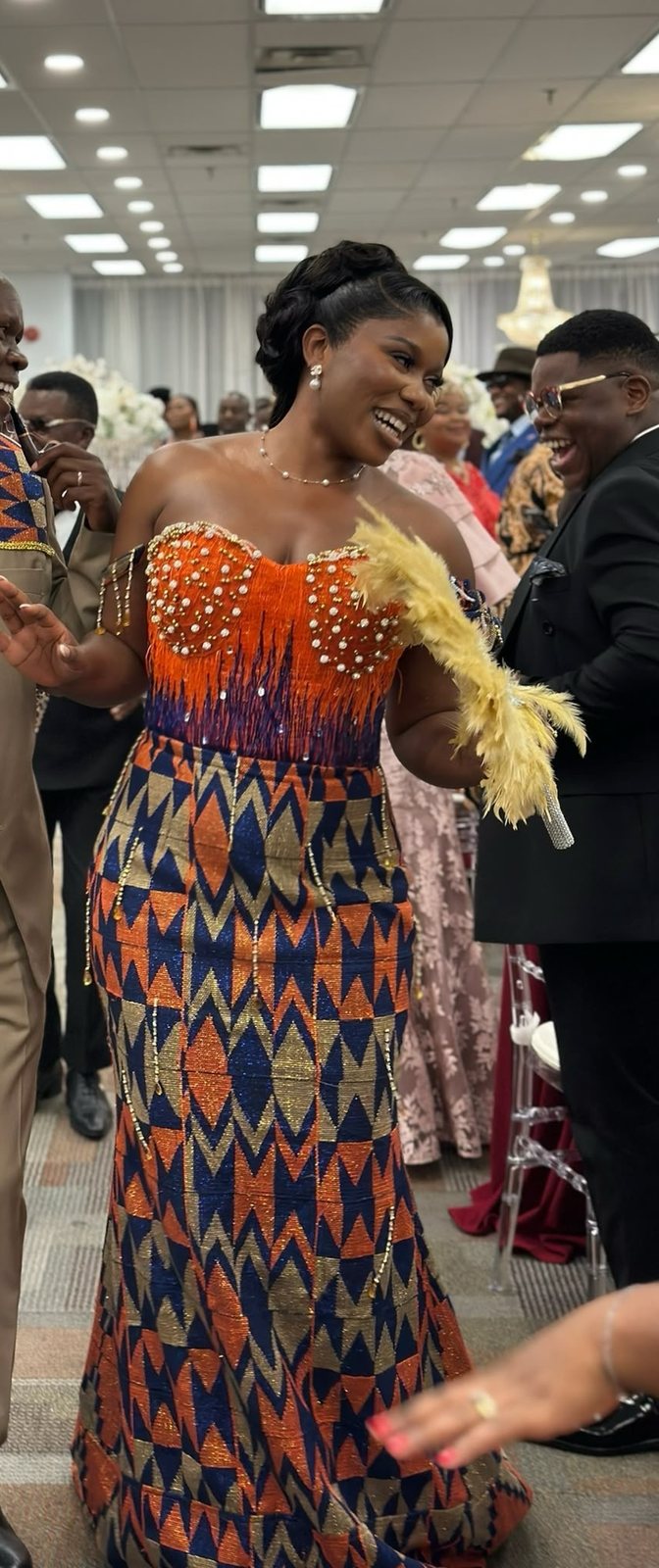Mermaid gown in orange, blue and gold kente, with a beaded orange bodice
